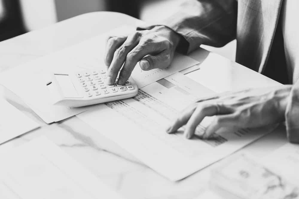 Business analyst calculating turnover figures in office